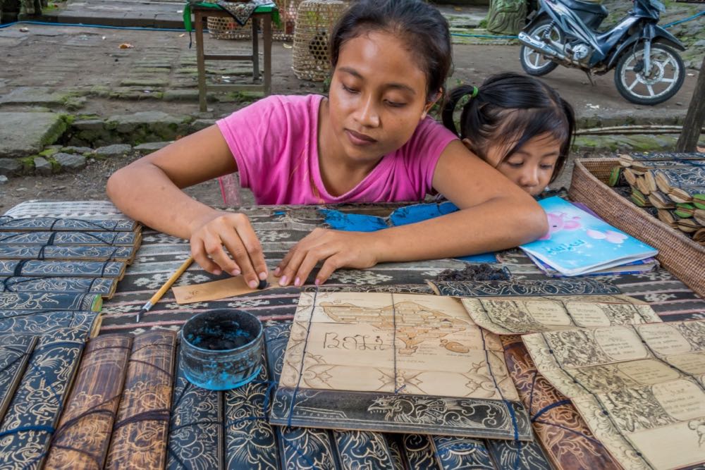 Balinese girls uses templates for her art
