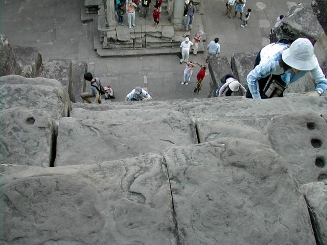 Tourists climbing the steps in Siem Reap