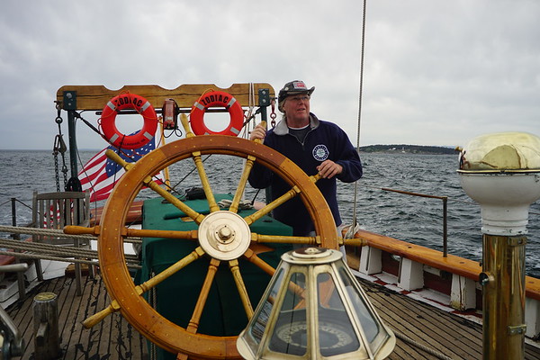 Jed Vaughn at helm of Schooner Zodiac