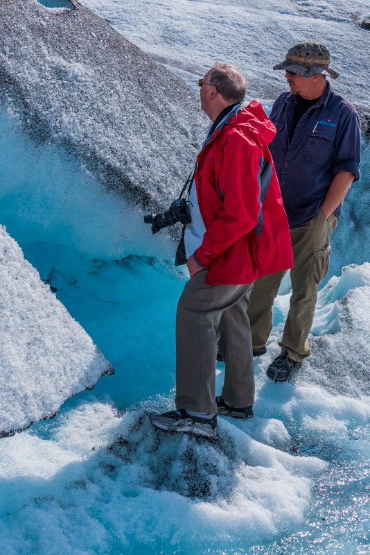 walking on a glacier in Alaska with our helicopter pilot