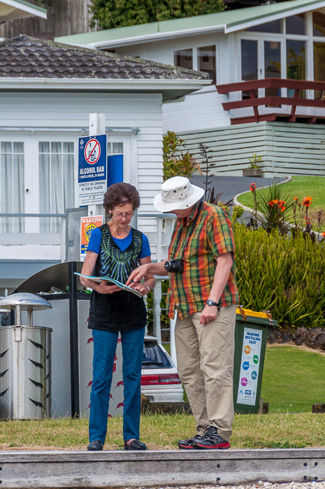 Roy and his sister study a map on a local tour