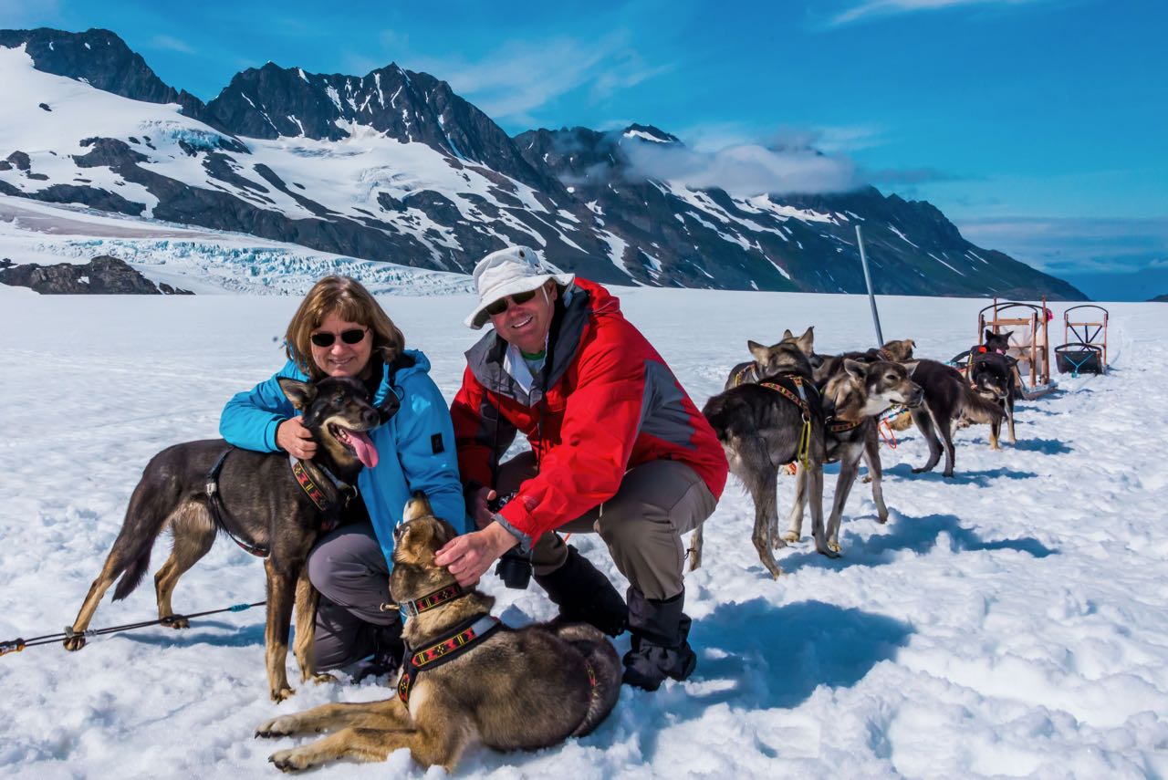 Playing with dogs at dog-sled camp in Alaska