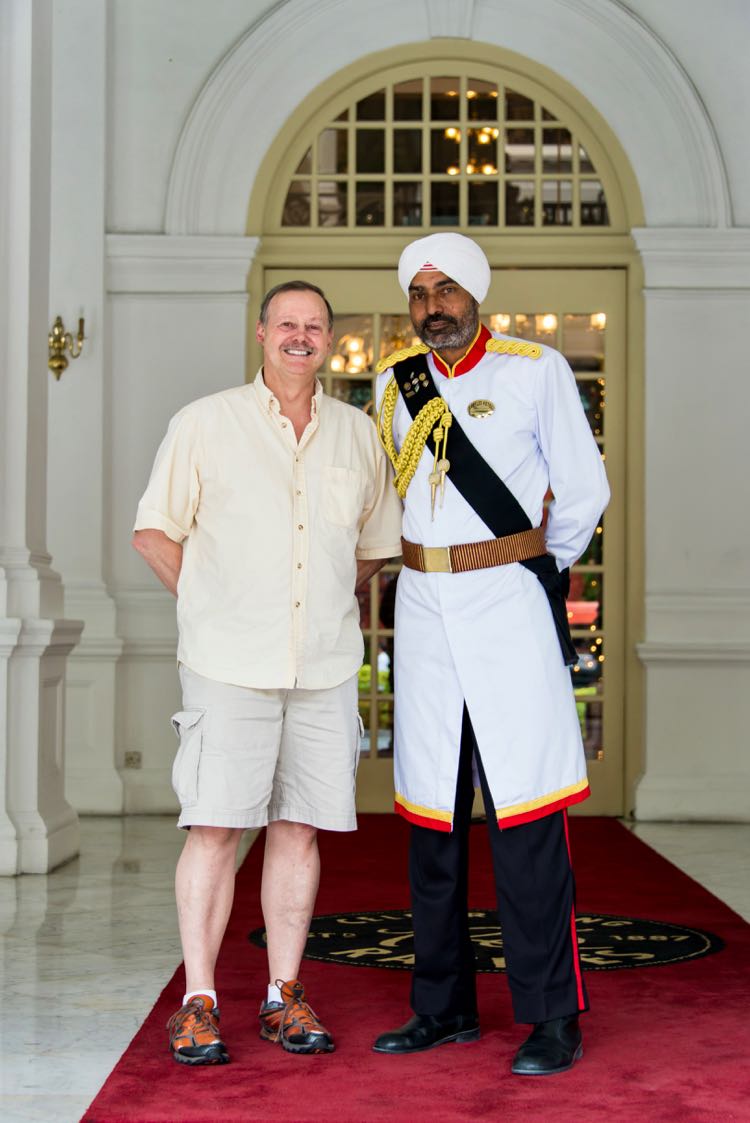 Roy Stevenson poses with Sikh doorman at Raffles Hotel, Singapore